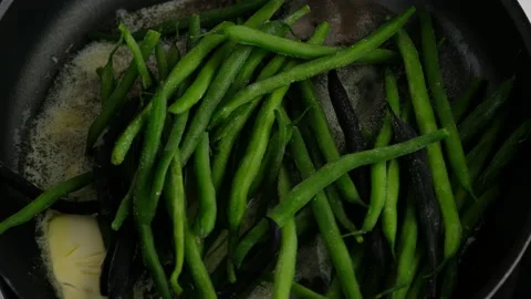 Green beans with spices ready for cooking in frying pan. Bio green beans Stock Footage 153402870