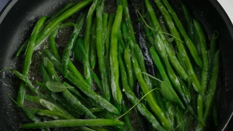 Green beans with spices ready for cooking in frying pan. Bio green beans Stock Footage 153403106