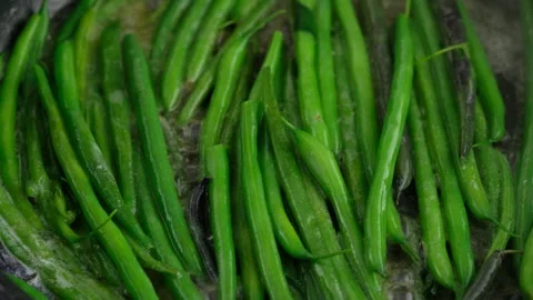 Green beans with spices ready for cooking in frying pan. Bio green beans Stock Footage 153403381