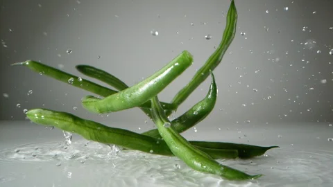 Green beans on water surface. Slow Motion. Video stock 128771478