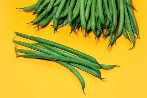Green beans on a yellow background. copy space. Stock Photos