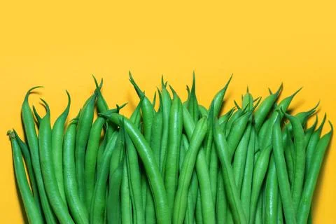 Green beans on a yellow background. copy space. Stock Photos