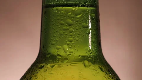 Green beer bottle rotate and close-up in slow motion Stock Footage 144321891