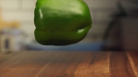 Green bell pepper falling on a table in slow motion Stock Footage 152904252