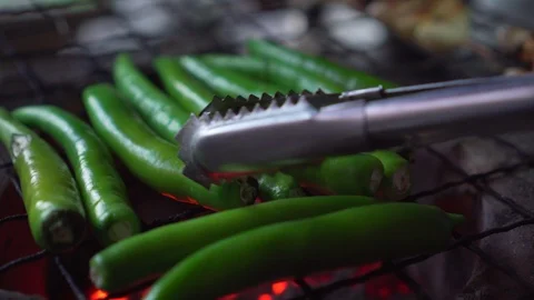 Green bell pepper getting grill on charcoal grill. hot fire under. flip it. Stock Footage 120024422