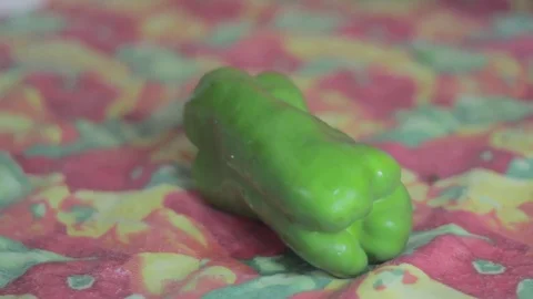 Green bell pepper hit strong and sliced cut in the middle Stock Footage 79537647