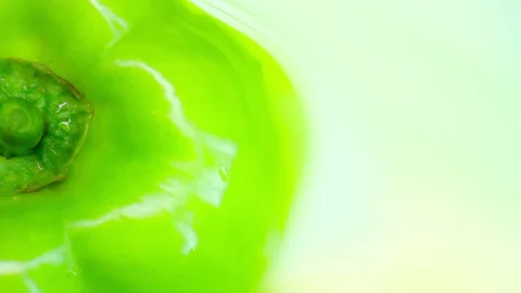 Green bell pepper on a rotating green background. Copy space. top view. Closeup Video stock 128465133