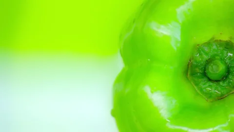 Green bell pepper on a rotating green background. Copy space. top view. Closeup. Stock-Footage 129721237