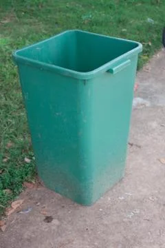 Green bin located in the park. Stock Photos