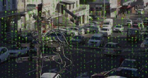 Green binary code animation over busy urban street with cars and power lines Stock Footage 306285070
