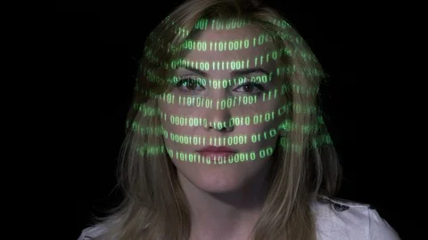 Green binary code projected on the face of an sexy smart software developer f Stock Footage 86435472