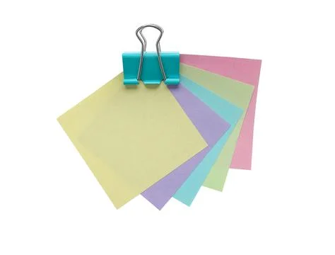 Green binder clip and five colored notes  Stock Photos