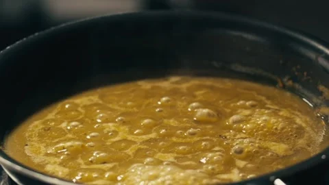 Green boiling sauce texture close-up macro. Cooking green curry with wooden Stock Footage 277417601