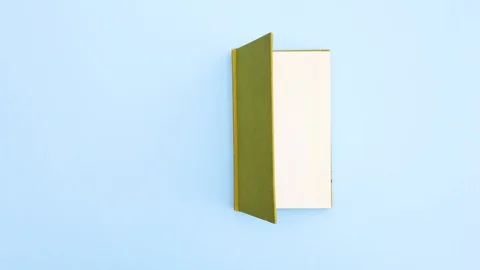 Green book appear and opens - Stop motion Stock Footage 129477443