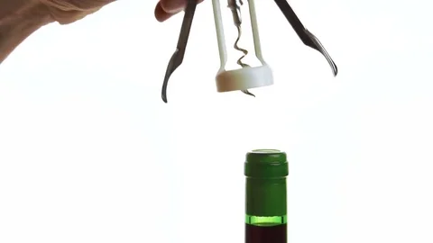 The green bottle is being opened by chiefs hands with corkscrew in the Stock Footage 82356383