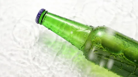 Green bottle of cold beer with water drops falling down on glass, refreshing Stock Footage 165159490