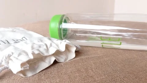 Green bottle drink on a brown table Stock Footage 146246882