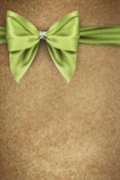 Green bow on texture of paper packaging Stock Photos