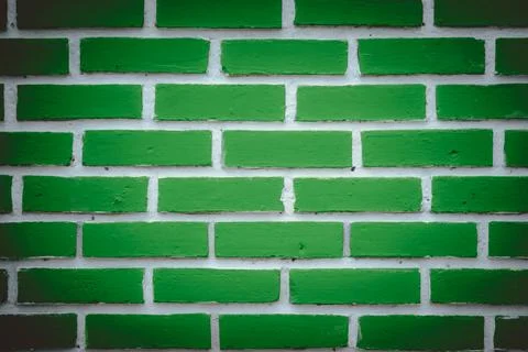 A green brick wall with white bricks in between Stock Photos