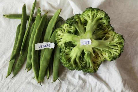 Green broccoli and string beans on white background with copy space. Mock-up. Stock Photos