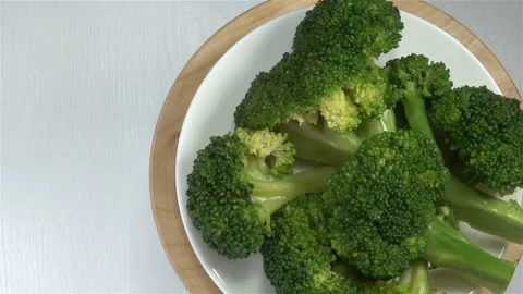 Green broccoli cabbage on a plate rotate Stock Footage 145961650