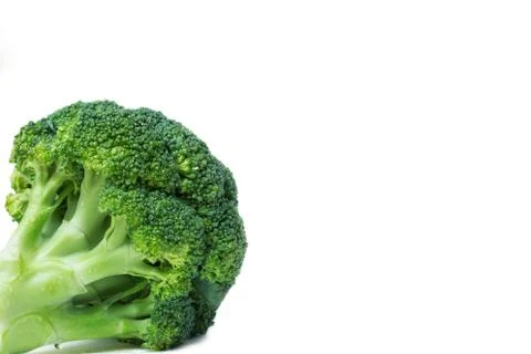 Green broccoli on white isolate background. In the lower left corner. Vegetab Stock Photos