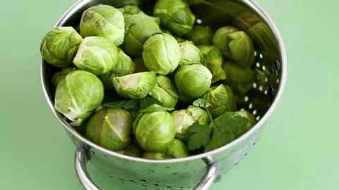 Green Brussels sprouts in a colander Stock Footage 330951120