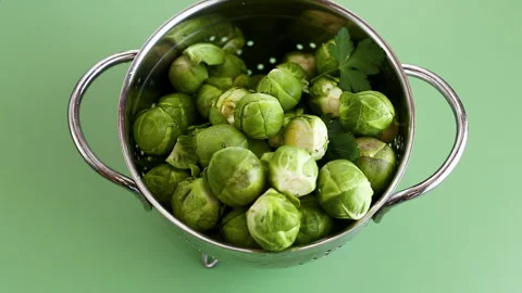 Green Brussels sprouts in a colander Stock Footage 332728673