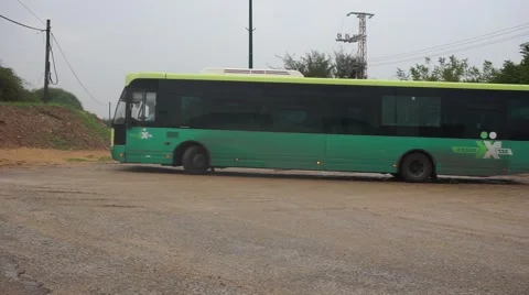 Green bus turn, puddle in the background NOV 2015 Stock Footage 56707633