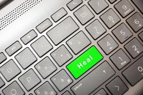 Green button on the computer with the text Heal Stock Photos
