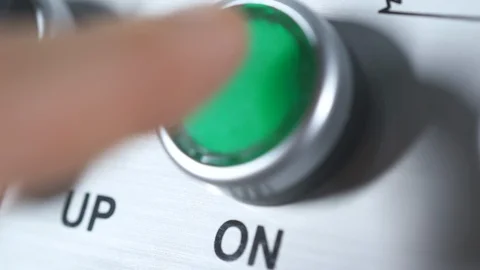 Green button power on. Finger pushing button. Switch on. Turn on the electricity Stock-Footage 127214535
