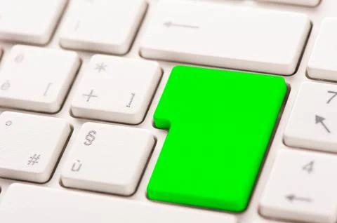 Green button on a white keyboard Stockfoto's