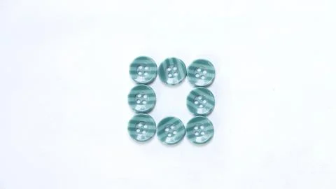 Green buttons arranged in square shape neatly on a white background 写真素材