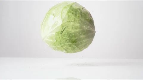Green Cabbage Bouncing Slow Motion White Tabletop Closeup Macro Food Studio Stock Footage 335004678