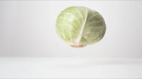 Green Cabbage Bouncing Slow Motion White Tabletop Closeup Macro Food Studio Stock Footage 335005889