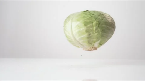 Green Cabbage Bouncing Slow Motion White Tabletop Closeup Macro Food Studio Stock Footage 335006857