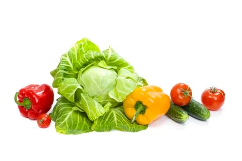 Green cabbage. Yellow pepper. Red tomatoes and cucumbers on a white background Stock Photos
