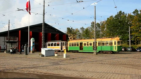 A green cable car in front of a tram depot Stock Footage 42672479