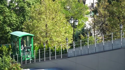 Green cable car rises with people on the background of trees Stock-Footage 163352302