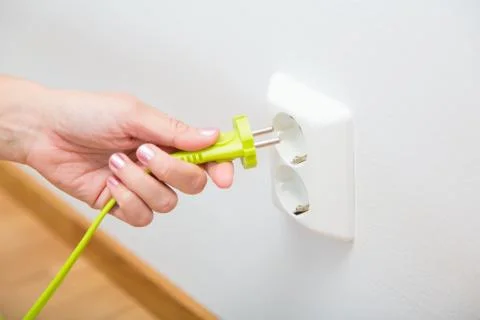 Green cable in a grounded wall plug Foto stock