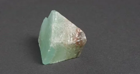 Green calcite on a dark background. A common mineral. Ornamental stone. Video stock 163787045