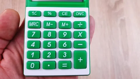 Green calculator with buttons on the table. Calculator, financial concept. Stock Footage 299727903