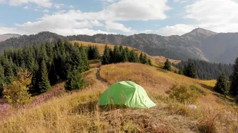 Green camping tent in the mountain forest Видео 141167415
