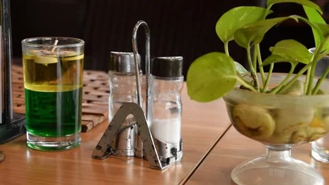 Green candle salt and small plant on hotel restaurant table Stock Footage 312688151