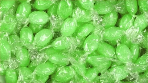 Green Candy In Wrappers Rotating Stock Footage 77665673