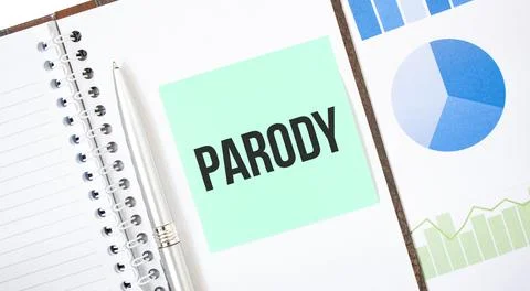 Green card on the white notepad. Text Parody. Business concept Stock Photos