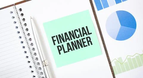 Green card on the white notepad. Text FINANCIAL PLANNER. Business concept Stock Photos