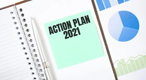 Green card on the white notepad. Text ACTION PLAN 2021. Business concept Stock Photos