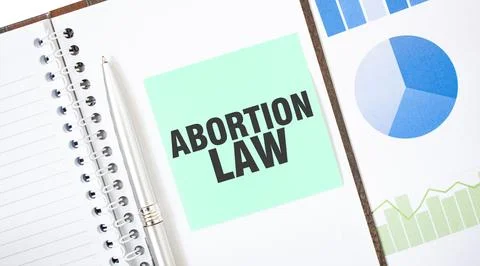 Green card on the white notepad. Text ABORTION LAW. Business concept Foto stock