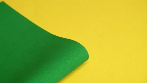 Green cardboard on a yellow background. Stock Footage 157393220
